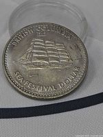Obverse of 1978 British Columbia Sea Festival Dollar showing ship design and legends