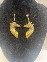 Front view of both giraffe earrings on display stand