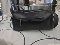 Front/top view displaying overall bag shape, rear zip pocket and zipper closure