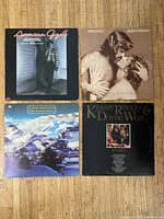 Front view of four vinyl LP jackets