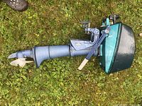 Full view of Evinrude outboard motor showing propeller, drive shaft and engine cowling