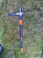 Full view of Fiskars stand-up weeder on grass