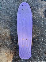 Top view of purple Penny skateboard deck