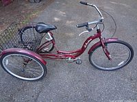 Left side view of burgundy Schwinn Meridian adult tricycle with rear basket