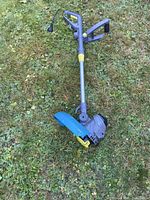Full view of Yardworks electric grass trimmer on lawn