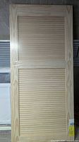 Full front view of the pine louvered door in shrink wrap