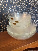 Stacked frosted glass bowls on shelf