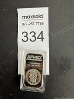 Front view of sealed APMEX silver bar with weight and purity text