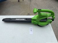 Left side view of green Portland electric blower showing nozzle and handle