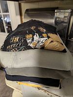 Stack of folded tops showing variety of colours and fabrics