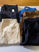 Stack of six folded pants showing colour assortment