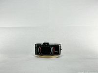 Front view of Le Mini camera showing lens area and accents