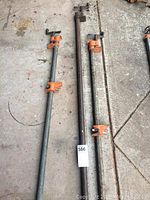 Set of three pipe clamps laid out for size comparison, showing lengths of 71, 52, and 45 inches with orange tightening handles