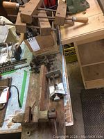 Wide view of the Smarts 66 bench vice, wooden clamps, doweling jig and additional small clamps arranged on a work surface showing the condition and relative size of items.