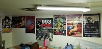 Wall with vintage posters including Kiss, Iron Maiden Killers, 993 Fox, Beatles Abbey Road, Kurt Cobain