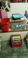 Photo showing plastic crates and bins filled with books and other items