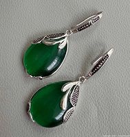Front view of both earrings showing green stones, silver setting and marcasite detail