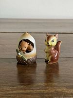 Front view of chipmunks in acorn figurine and standing squirrel miniature