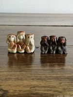 Front view showing both tan and dark brown three-monkey figurines