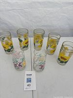 Group view of all seven printed glass tumblers on table