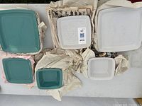 Mixed blue and white square plates and bowls wrapped in packing paper