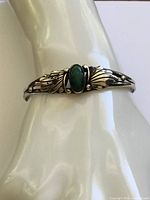Front view of cuff showing malachite stone and silver leaf design