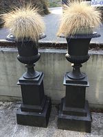 Both cast iron urn planters front view showing full height and pedestals