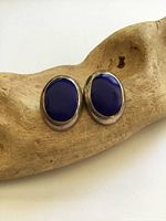 Front view of both oval lapis lazuli earrings in silver setting