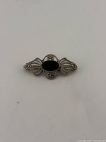 Front view of sterling brooch with black stone