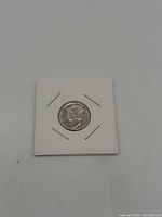 Obverse of Liberty silver coin secured in cardboard flip