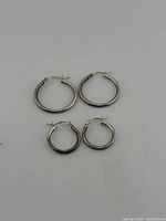 All four sterling hoop earrings displayed flat, sizes visible