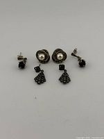 Three pairs of sterling silver earrings displayed front view