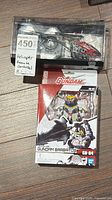 Overall view of sealed Gundam kit and Cherlead helicopter case