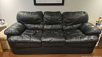 Front view of black leather 3-seater sofa