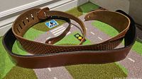 Full view of strap showing brown leather top and black suede lining