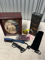 Full lot view: jewelry box, hair straightener with accessories, artificial plant