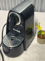 Front view showing Torrie logo, drip tray, brew lever