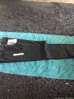 Full view of black Wrangler work pant laid flat
