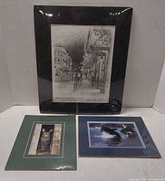 Framed Don Davey print centered with two smaller matted prints below