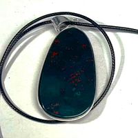 Front view of bloodstone pendant on cord