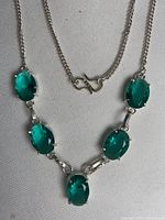 Full view of necklace showing five stones and chain