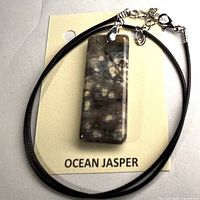Front view of pendant on card with cord