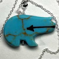 Front view of blue howlite bear pendant on chain