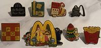 All eight pins laid out, showing designs and colors
