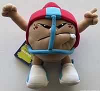 Front view of plush toy showing helmet, face, arms, shoes, hang tag