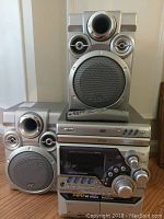 Front view of the stacked stereo system showing main unit, CD player, and two speakers.
