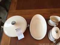 Covered casserole dish, oval vegetable bowl, cream and sugar with lid all white with platinum band and white floral pattern