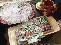Photo showing red snowman mug, Lefton Christmas tree shaped dish with cardinal and holly, small rectangular Hallmark trivet with Christmas patchwork design