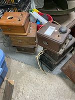 Stack of six oak telephone ringer boxes showing external condition and quantity