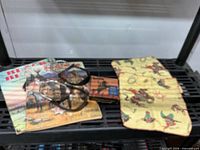 Lot overview showing colouring books, spurs, film box, handkerchiefs